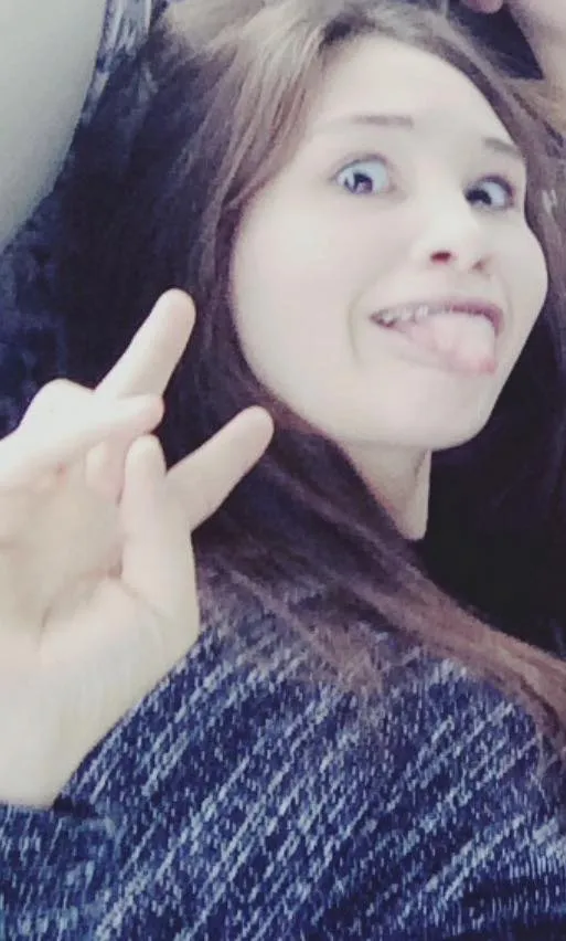 A bird sitting on a nest of eggs.